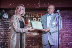 Janine Finnell, Founder and Clean Energy Ambassador, Leaders in Energy, presents the Baby Boomer Generation Award for Robert L. Wallace to Harry Holt, VP of Operations, Bithgroup Technologies.